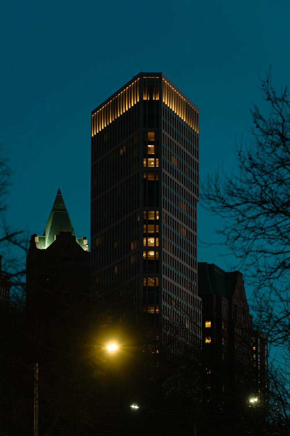 a tall building lit up at night in the city