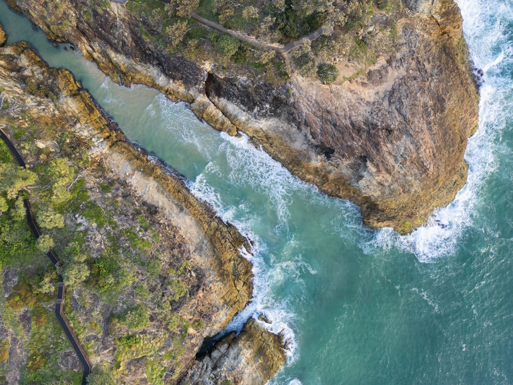 an aerial view of a body of water next to a cliff