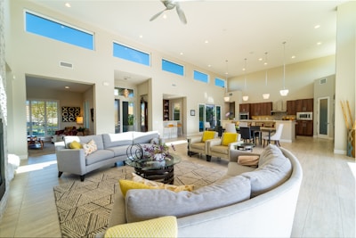 a living room filled with furniture and lots of windows