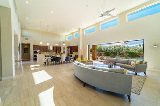 a living room filled with furniture and a large window