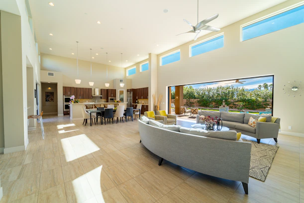 a living room filled with furniture and a large window