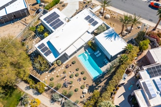 an aerial view of a house with solar panels on the roof