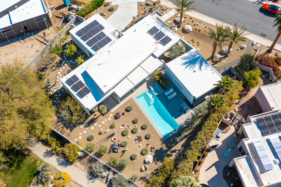 Aerial view of a house with solar panels on its roof