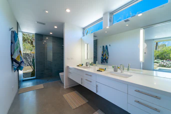 a bathroom with two sinks and a large mirror