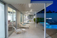 a modern house with a swimming pool at night