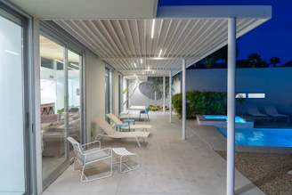 a modern house with a swimming pool at night