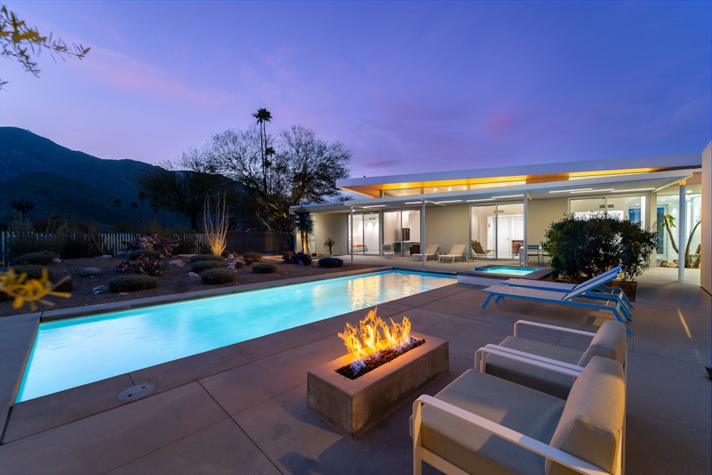 a fire pit sitting next to a swimming pool