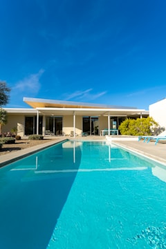 a large swimming pool in front of a house