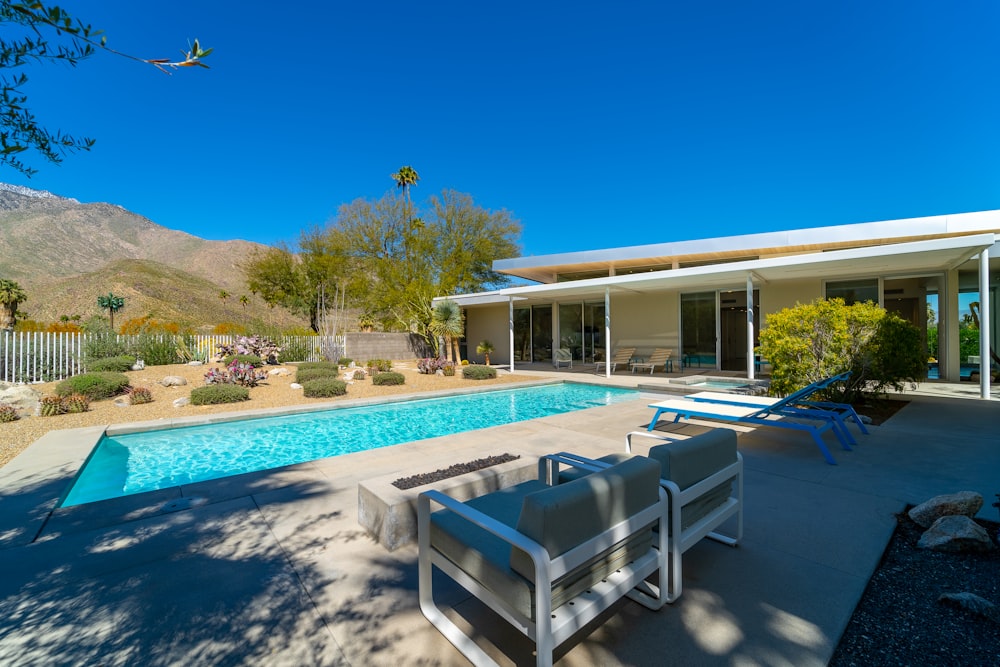 a house with a swimming pool and patio furniture