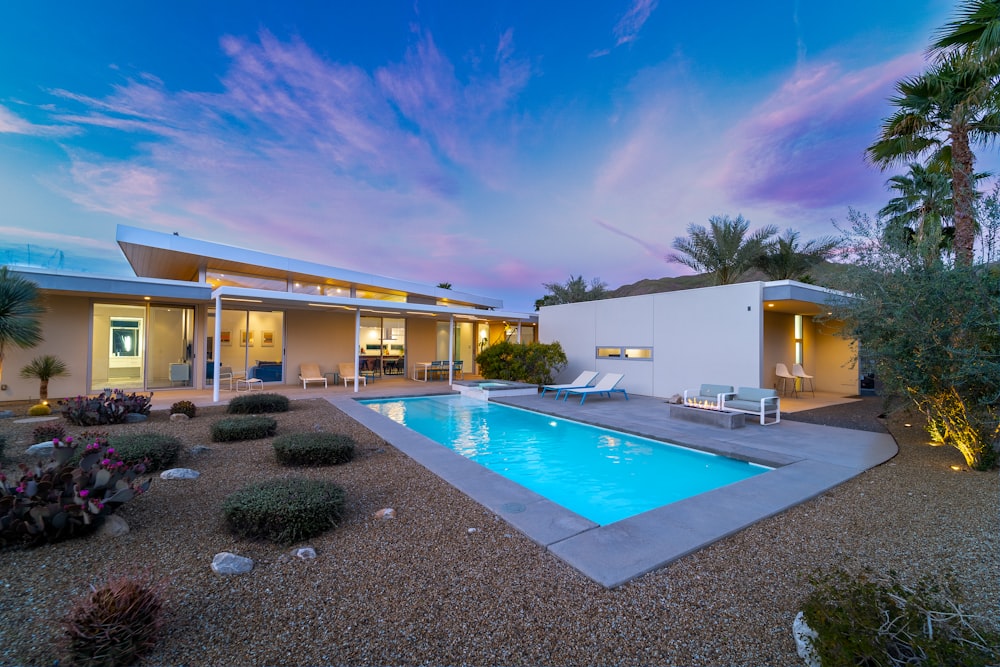 a house with a swimming pool in front of it