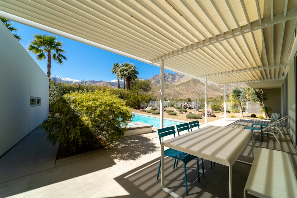 a covered patio with a table and chairs