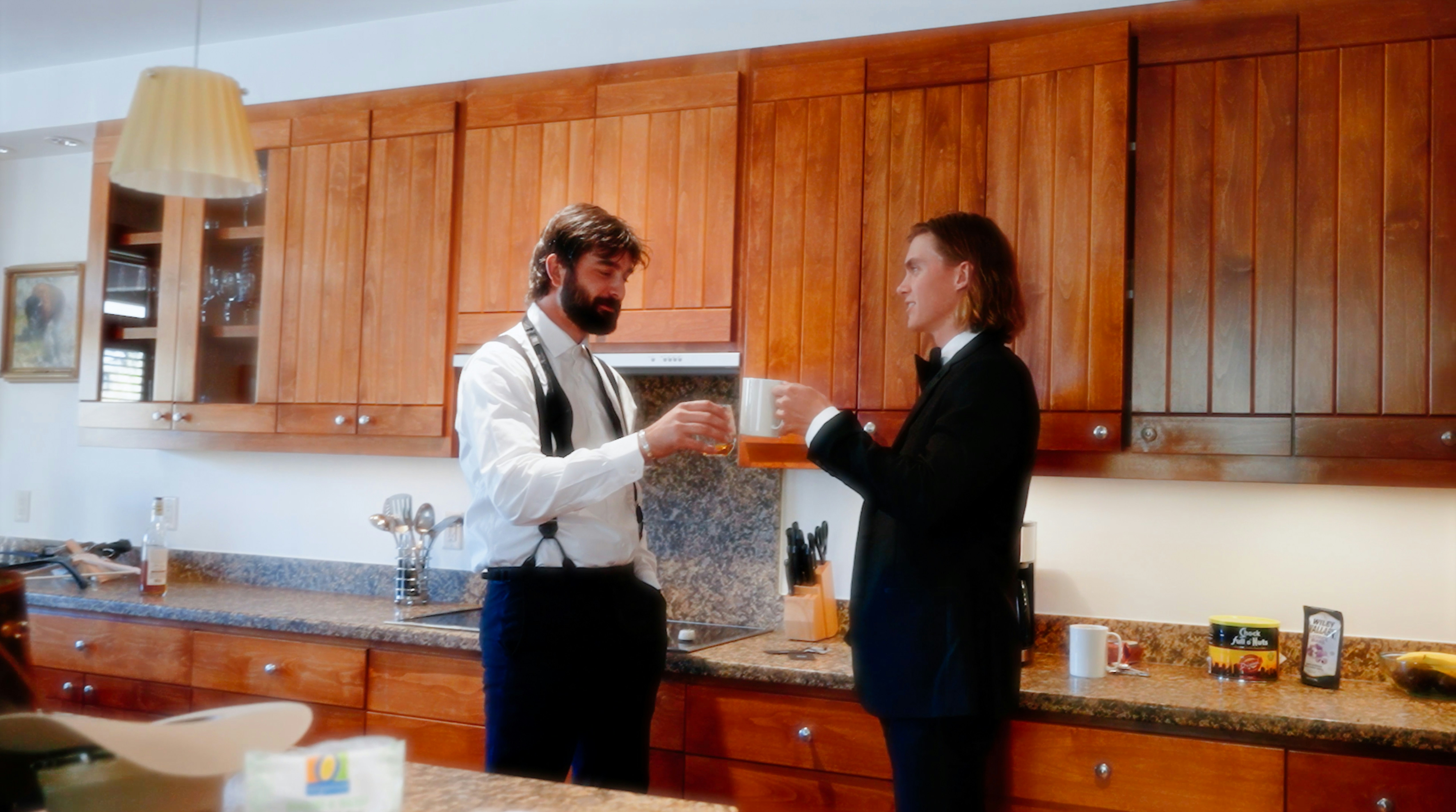 a man and a woman standing in a kitchen