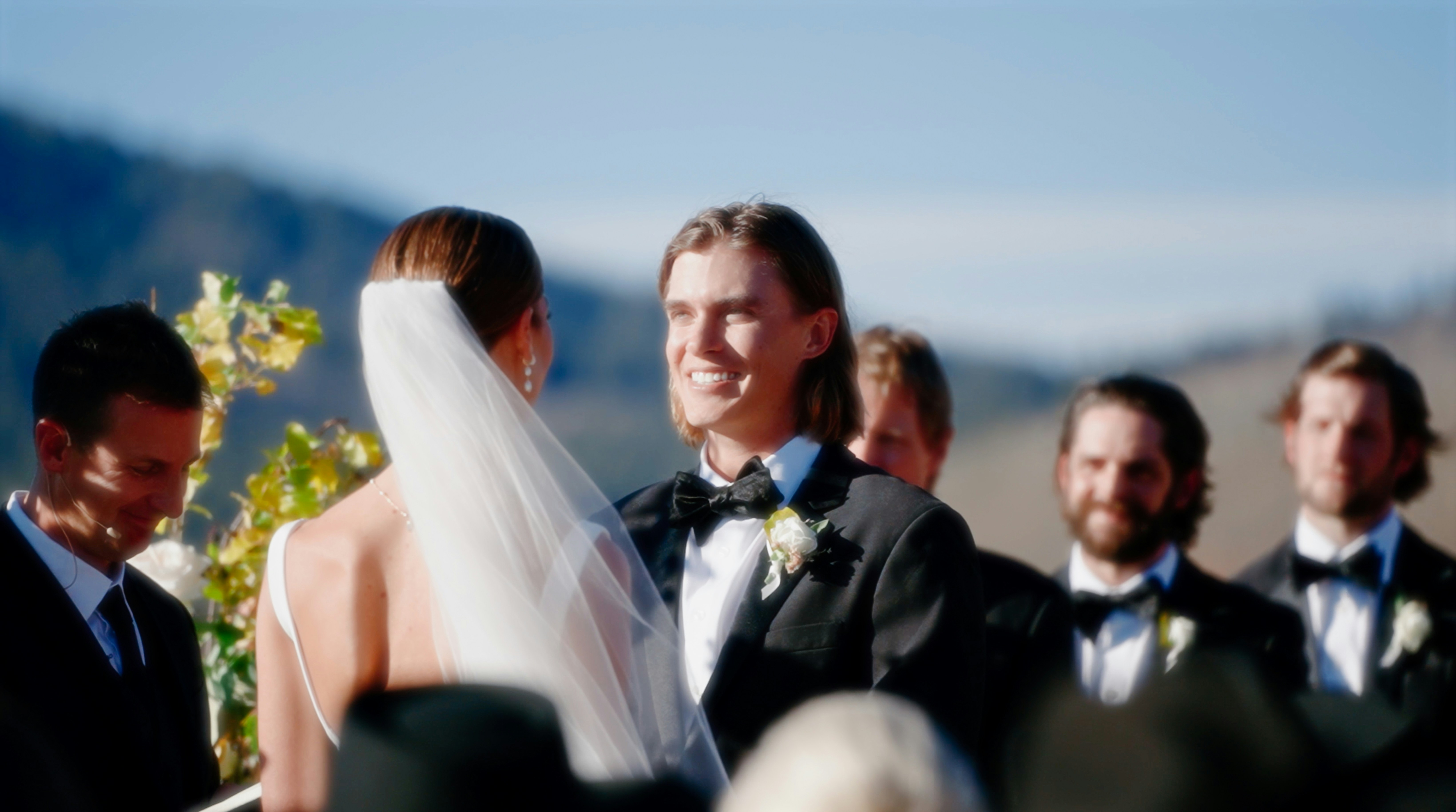 a man and a woman standing next to each other at a wedding