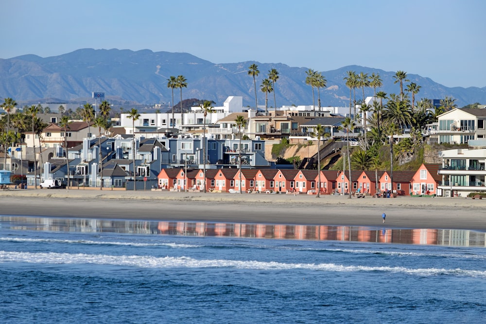 a view of a beach with houses in the background