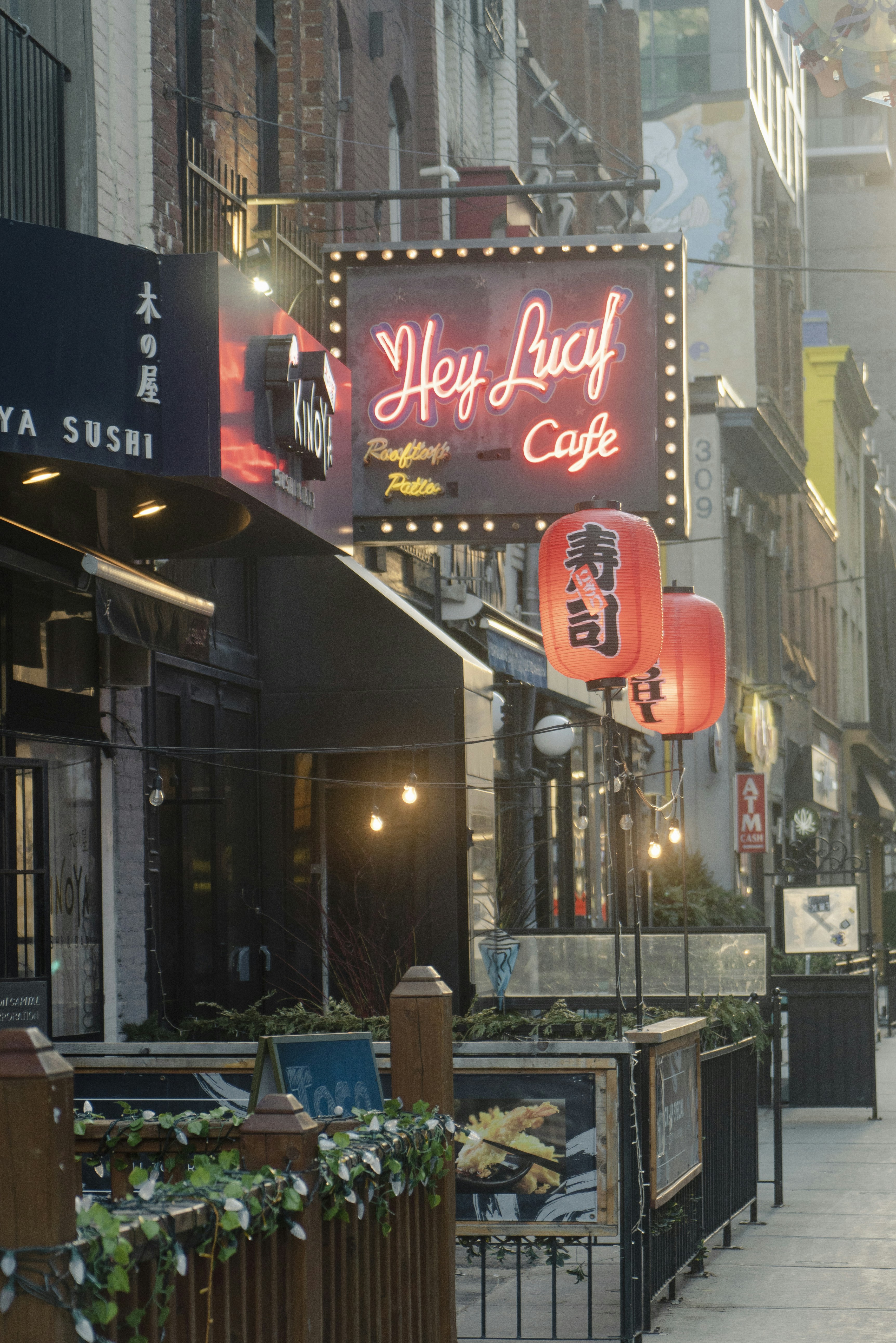 a city street with a sign that says hey luff cafe