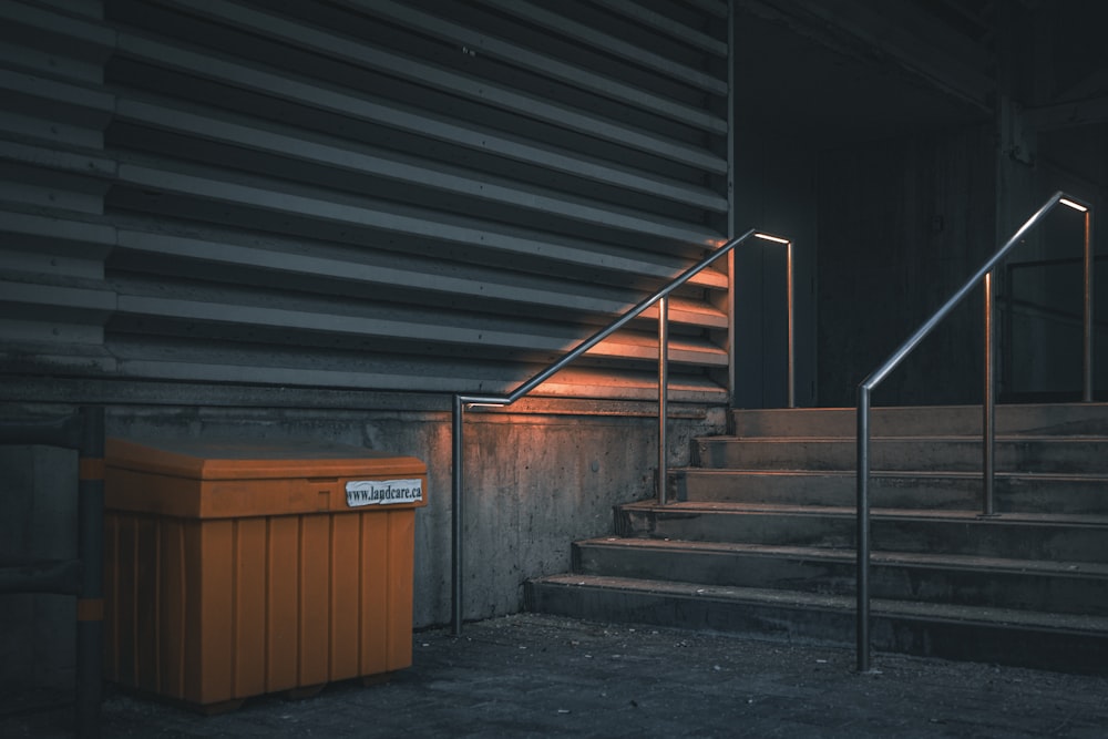 a set of stairs with a trash can next to it