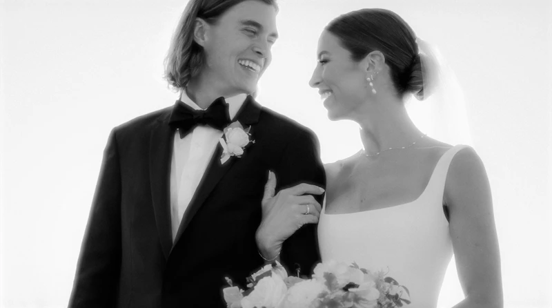 bride and groom smiling at each other