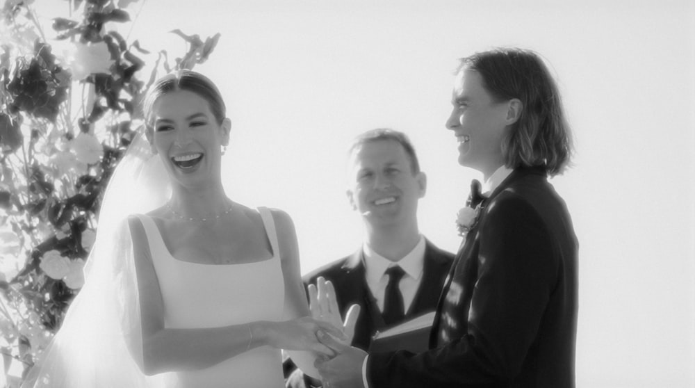 a bride and groom smile as they exchange vows