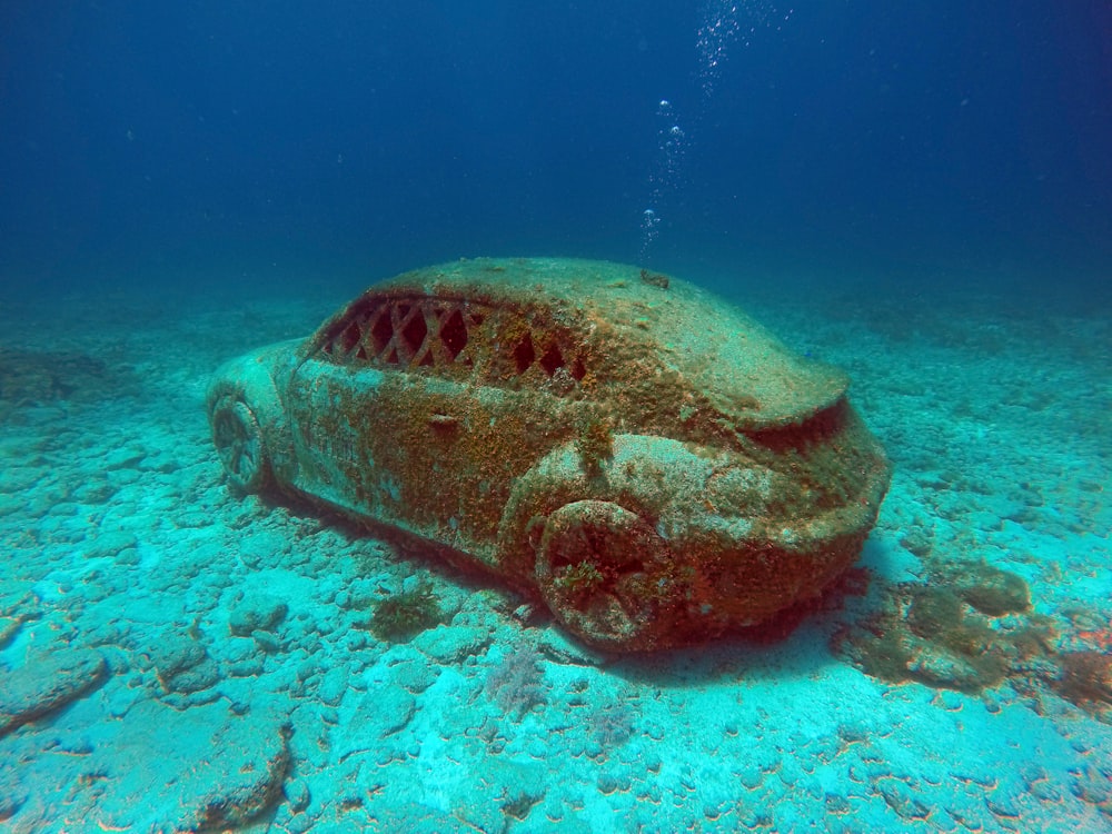 a car covered in sand under the water