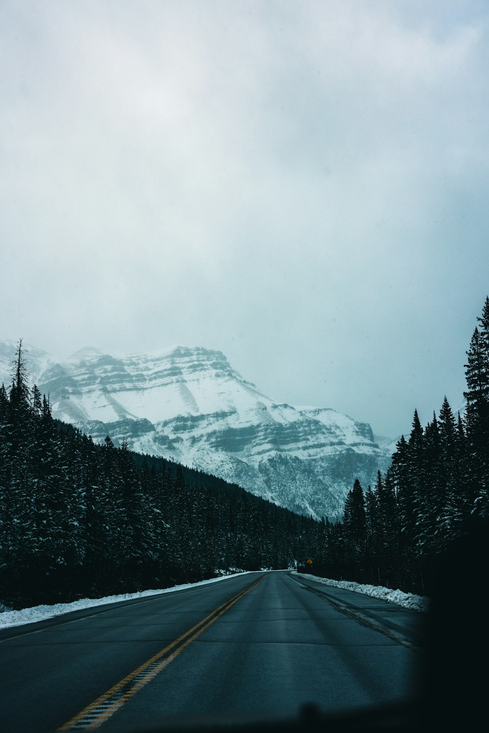 a road with a mountain in the background