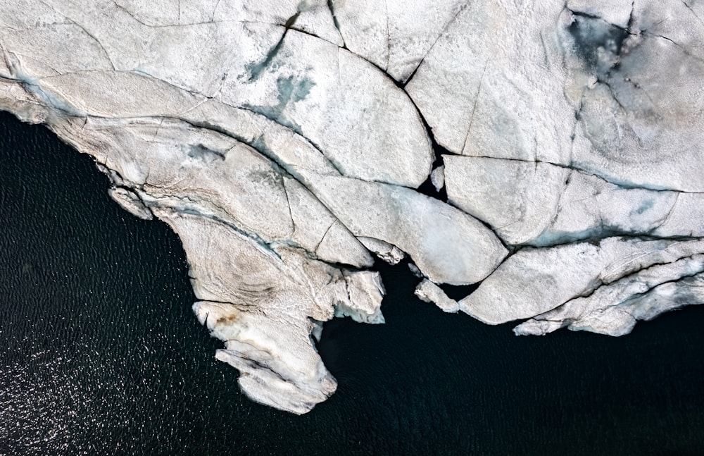 an aerial view of an iceberg in the water