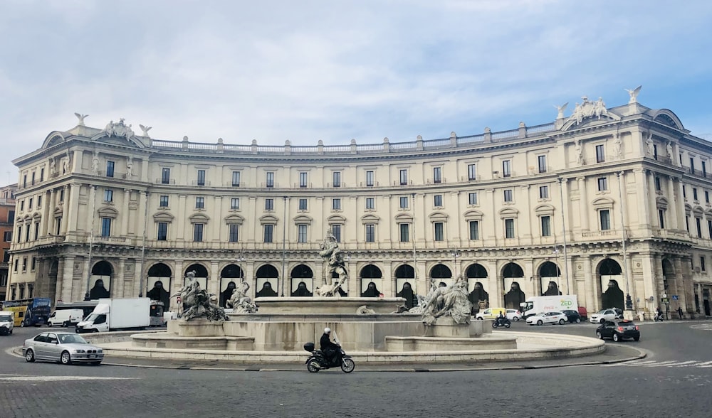 a large building with a fountain in front of it