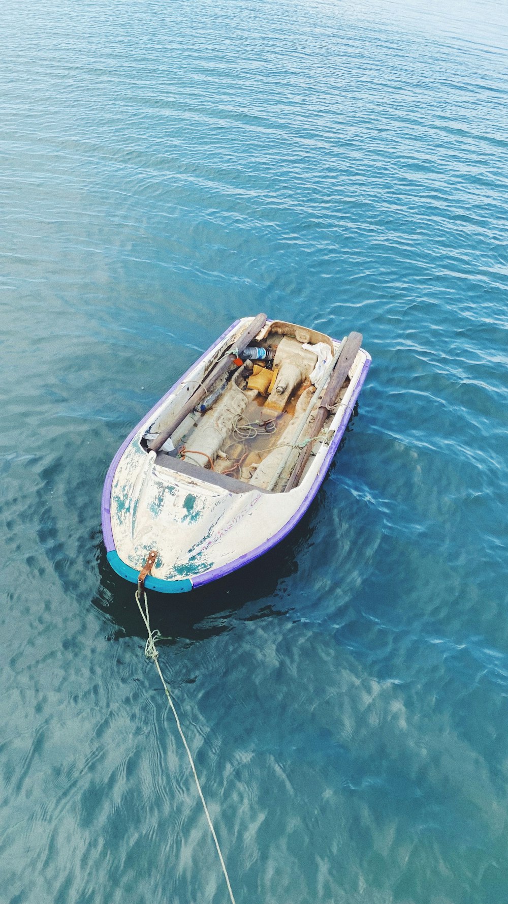 a small boat floating on top of a body of water