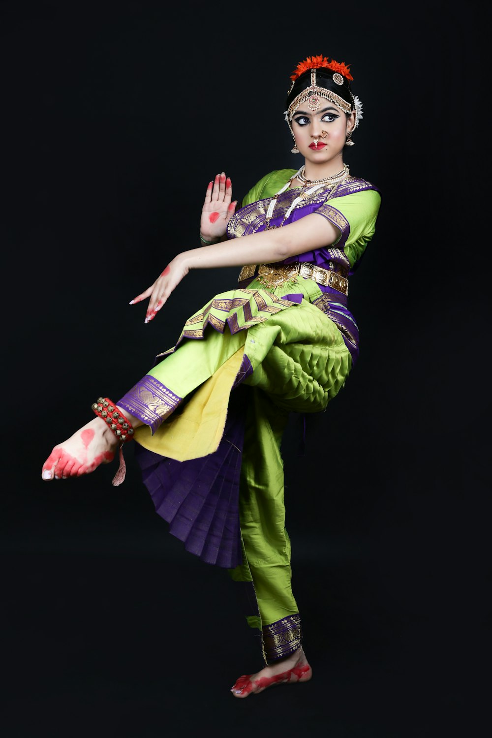 a woman in a green and purple outfit