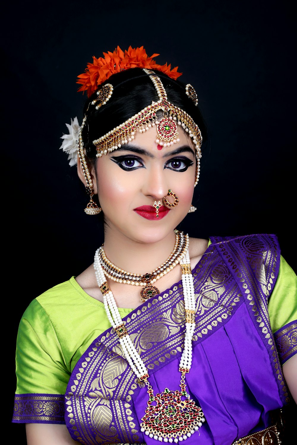 a woman in a purple and green sari