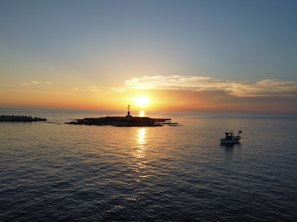 a small boat in the middle of a large body of water