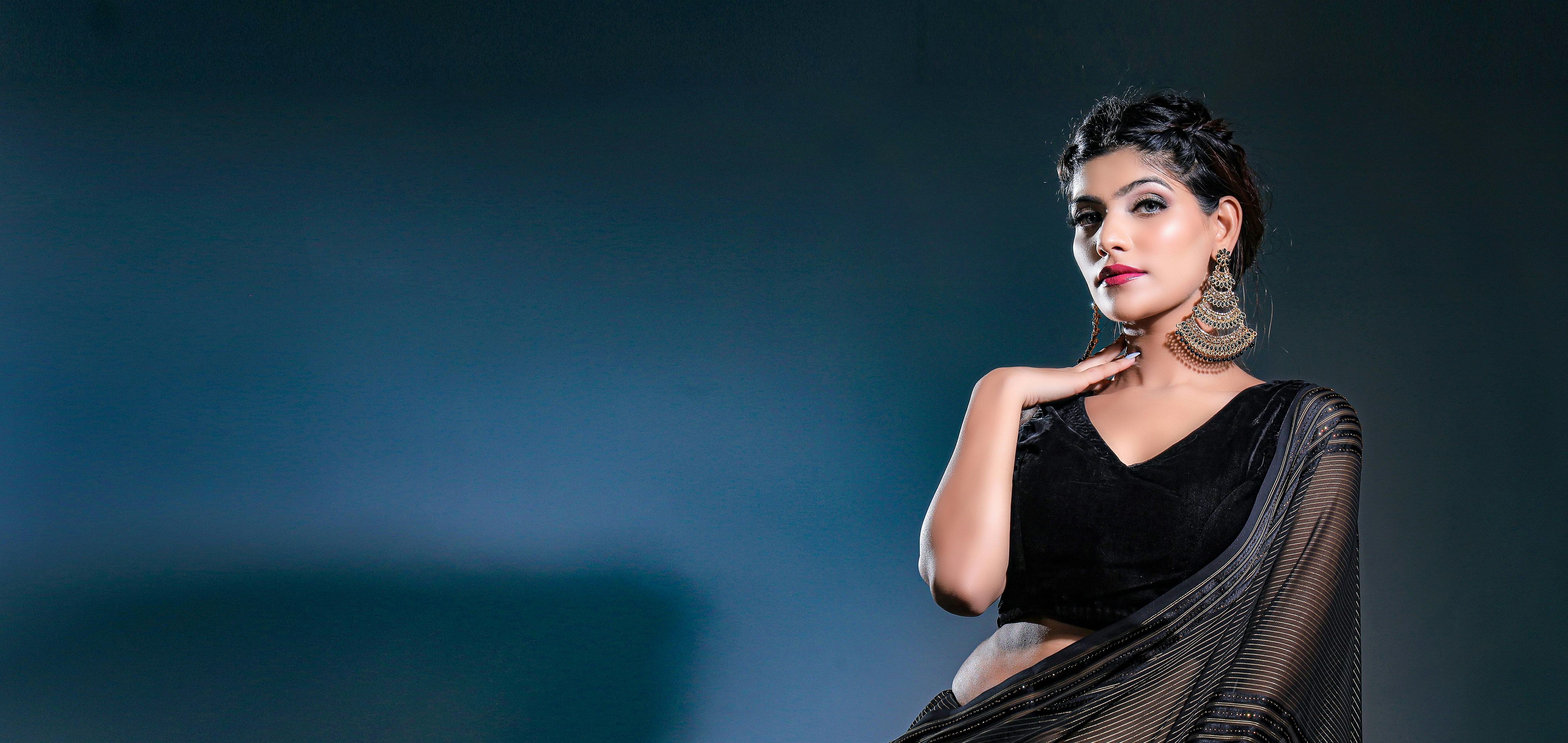 a woman in a black dress posing for a picture