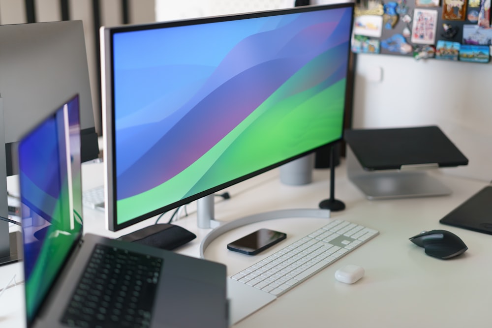 a desk with a computer monitor, keyboard and mouse