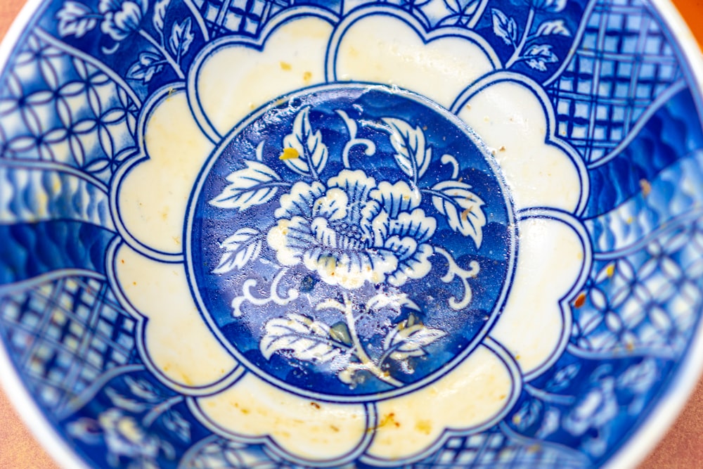a close up of a blue and white plate on a table