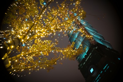 a tall building with lights on the top of it