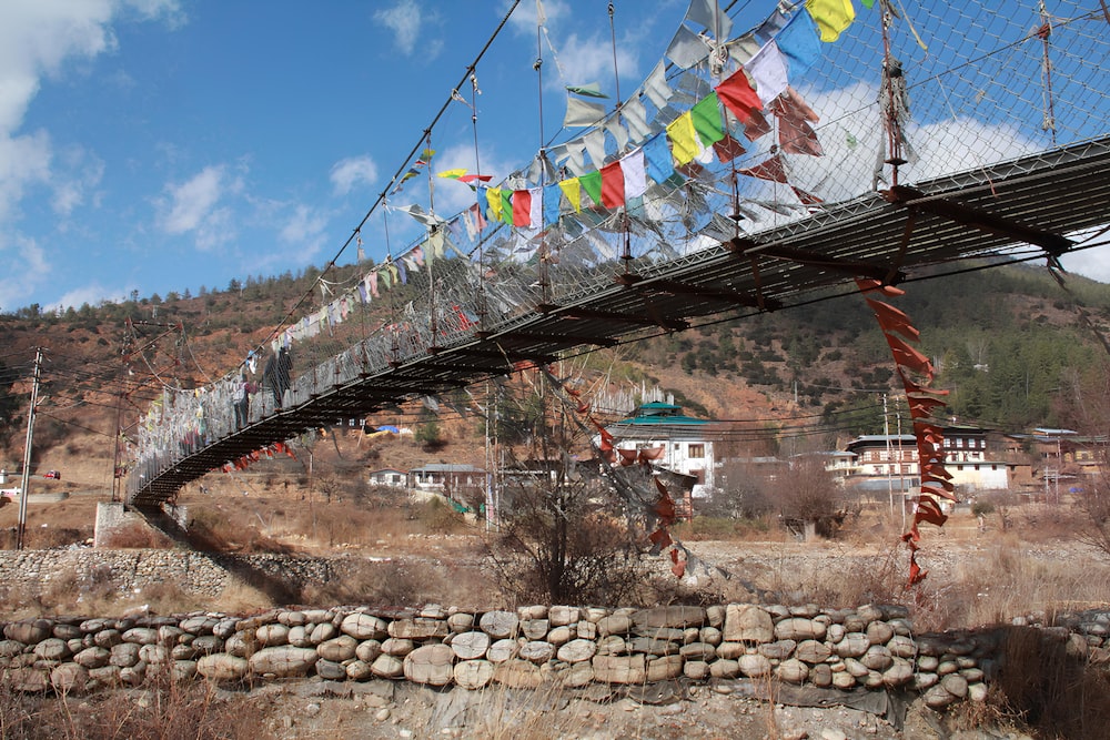 a bridge that has a bunch of flags on it