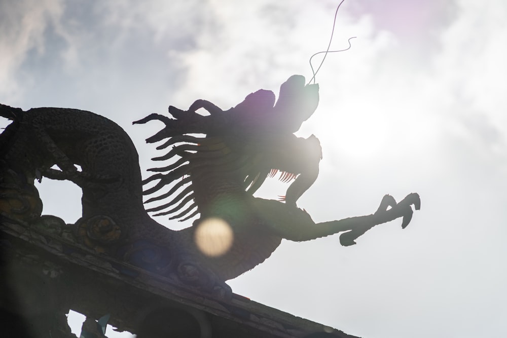 a statue of a man riding a horse on top of a roof