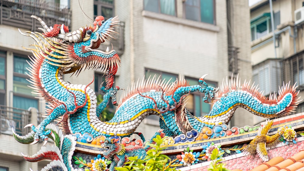 a dragon statue on top of a building