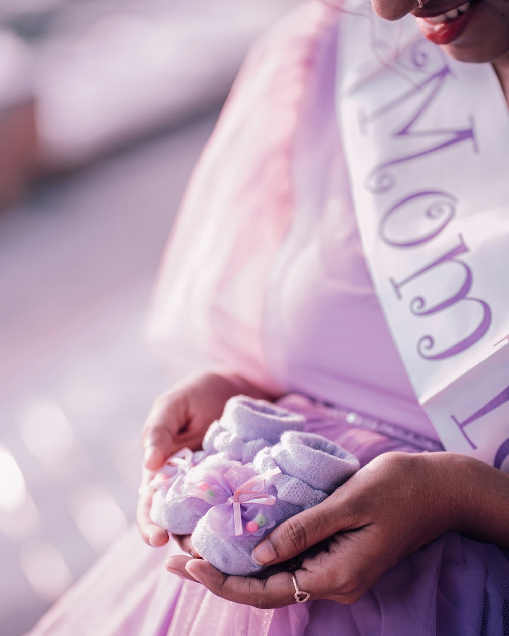 a woman in a purple dress holding a teddy bear