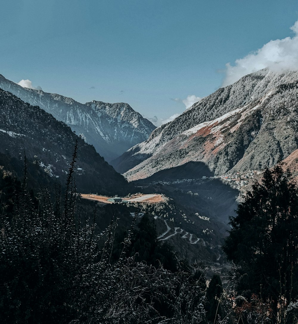 a scenic view of a mountain range with snow on the mountains