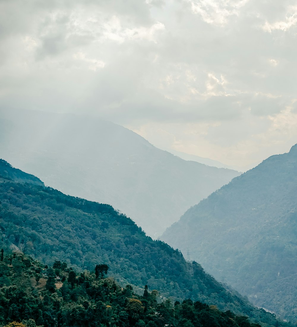 a view of a valley with mountains in the background