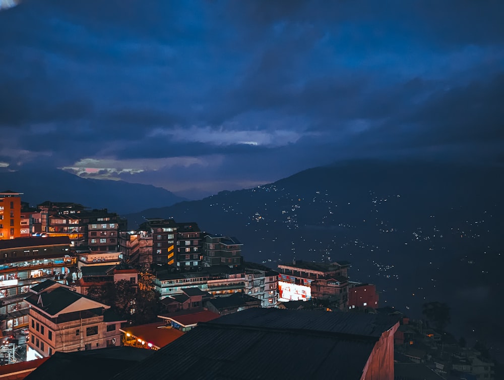 a view of a city at night from a hill