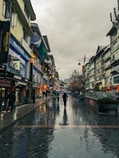 a group of people walking down a street holding umbrellas