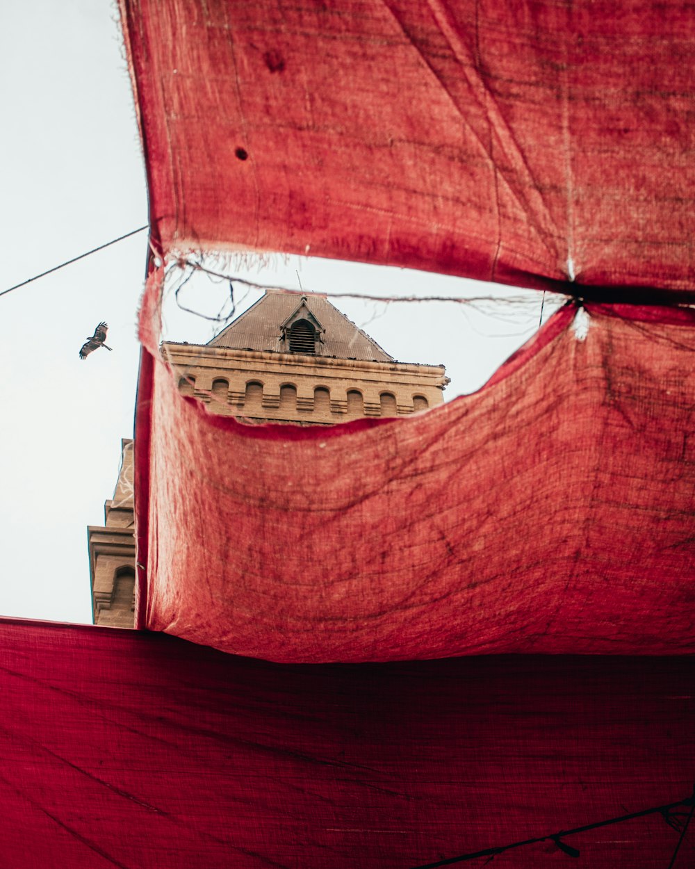 a red tarp with a building in the background