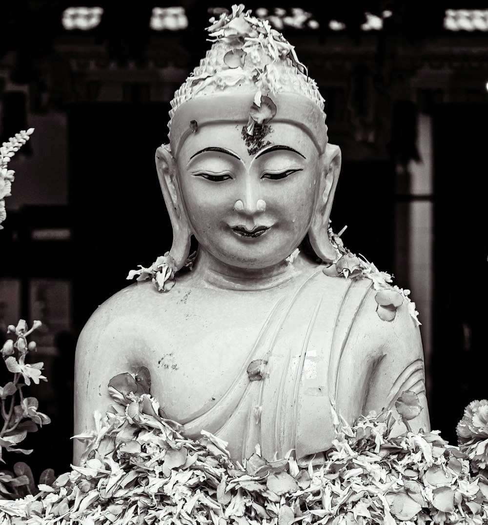 a black and white photo of a buddha statue