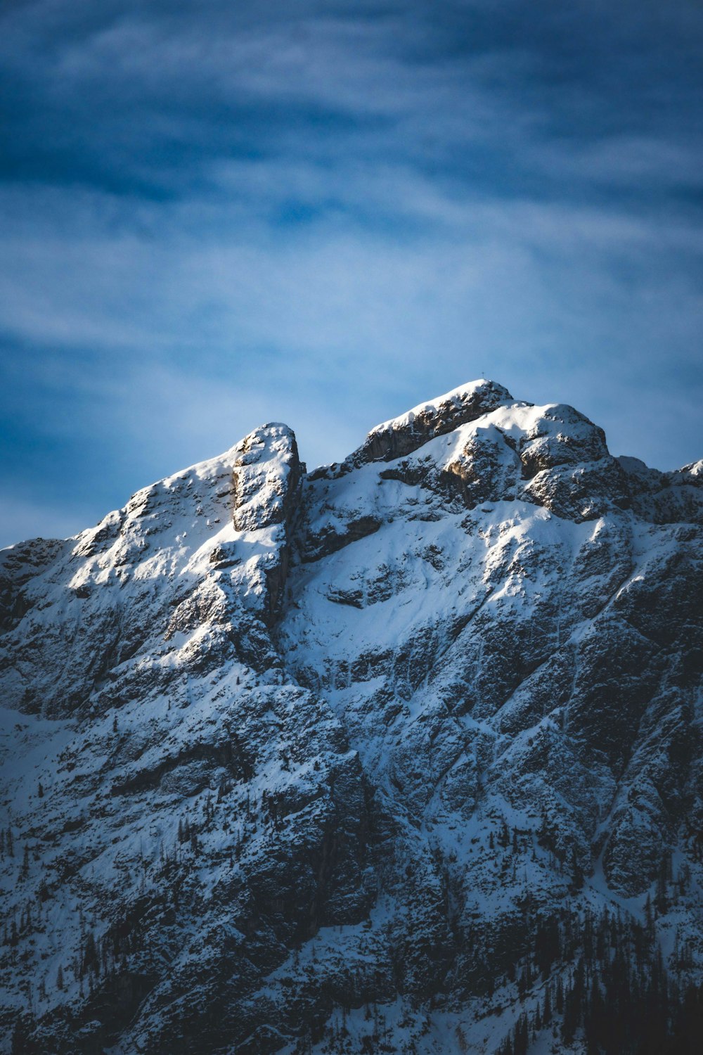 a mountain covered in snow under a blue sky