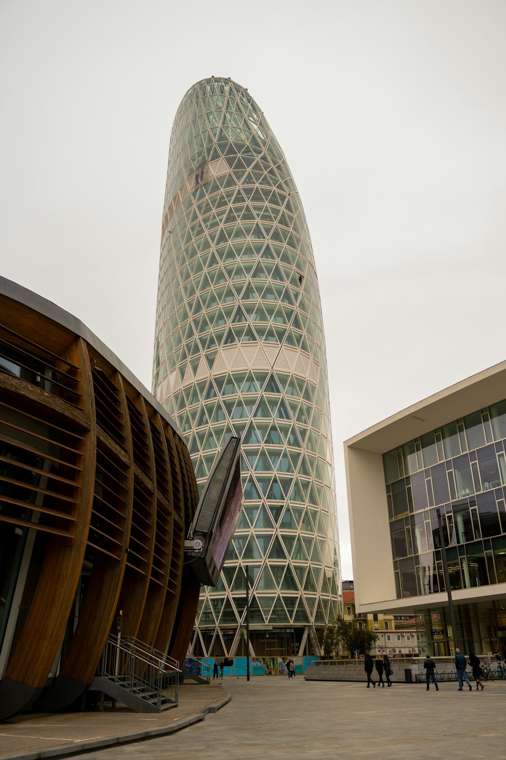 a tall glass building with a spiral design on it's side