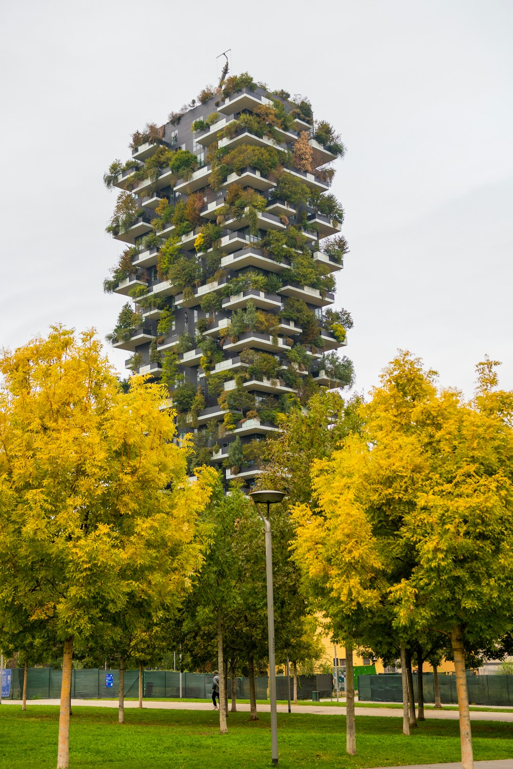 a tall tower with a bunch of plants on it