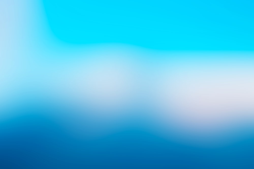 a blurry blue and white background with a white border