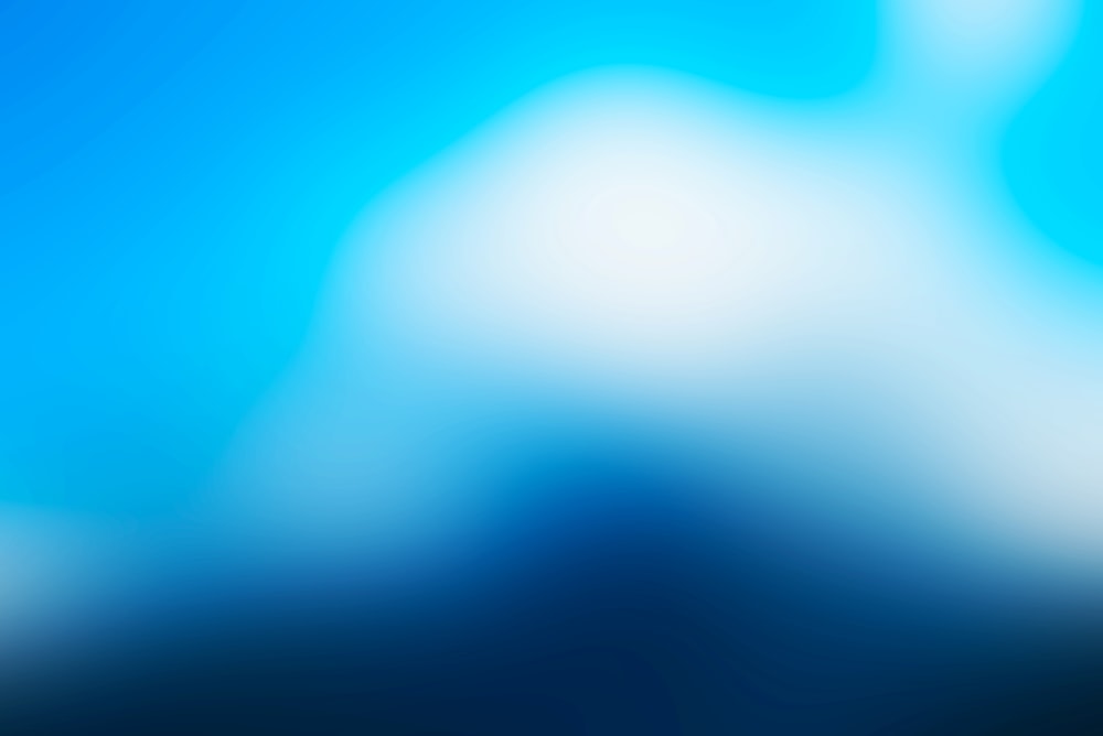 a blurry blue background with white clouds