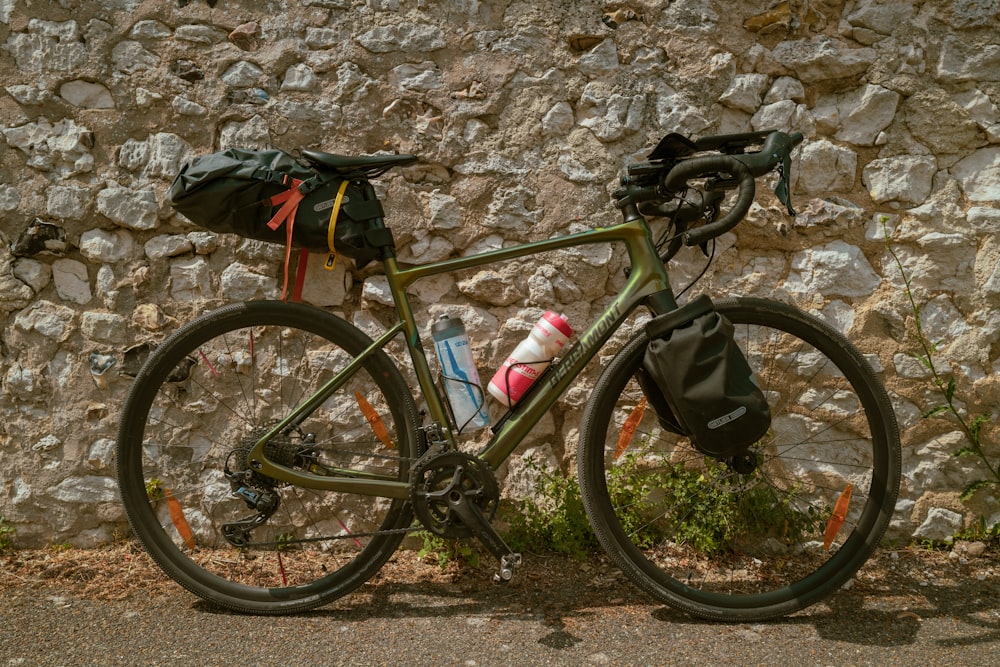 a bike parked next to a stone wall